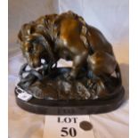 A bronze patinated model of a lion attaching a serpent bears signature 'FREMAET' to base est:
