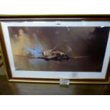 A large framed and glazed print of a Spitfire after the original by Barrie Clark bears printed
