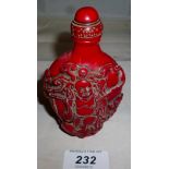 A large red lacquered snuff bottle decor