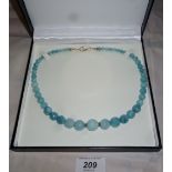 A faceted aquamarine necklace graduate s