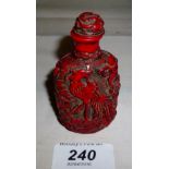 A Chinese red scent bottle decorated wit