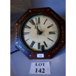 An octagonal wall clock with marquetry d