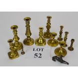 A collection of eleven miniature and small brass candlesticks;