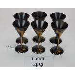 A set of six Japanese black lacquer sake cups painted with a cockerel on a cherry branch in gilt