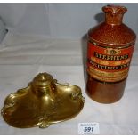 An old stone bottle of 'Stephens Red Writing Ink' unopened and a brass inkwell with flower