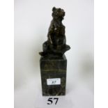A hot-cast bronze model of a bear on black marble plinth,