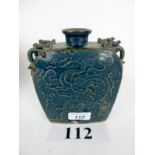 An oriental stoneware blue glazed vase with dragon handles and incised decoration et: £120-£180