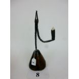 An 18th century wrought iron rush light nip and candle holder with oak counter weight on a
