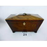 A late Regency mahogany and string inlaid tea caddy of sarcophagus shape with twin lidded