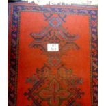 An early mid 20c Persian rug on red ground est: £35-£45