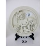 A carved marble relief plaque depicting three children after E W Wyon,