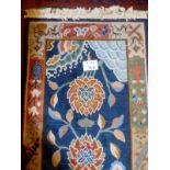 A thick piled chisel design rug depicting flowers on a blue ground est: £45-£65