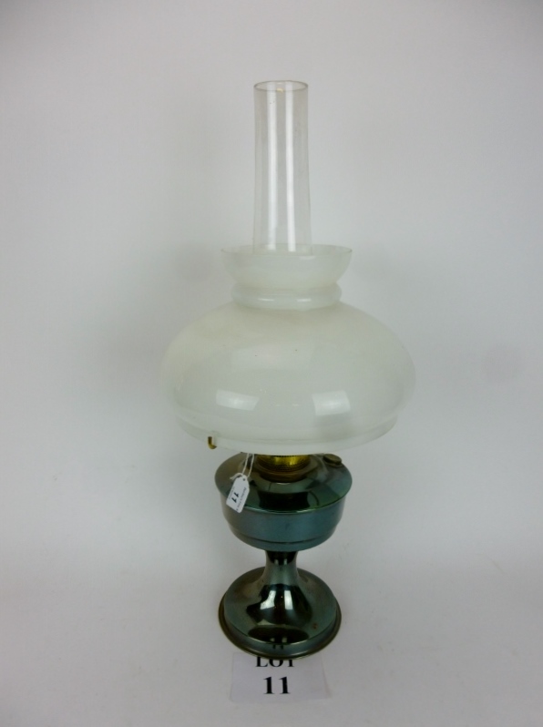 An oil lamp with opaque shade est: £15-£25 (G1)