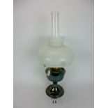 An oil lamp with opaque shade est: £15-£25 (G1)