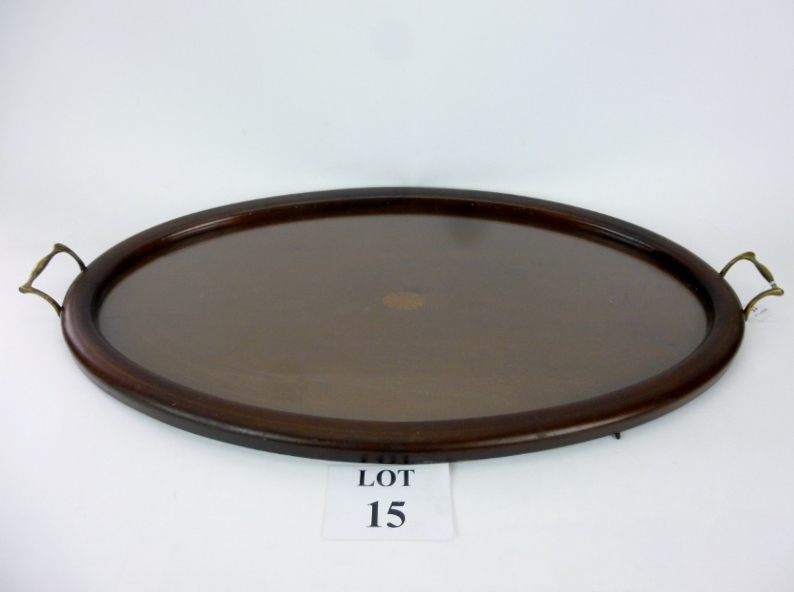 A large mahogany oval tray with brass bale handles,