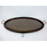 A large mahogany oval tray with brass bale handles,