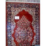 A 20c small Persian design rug on red ground (160 x 84 cm approx) est: £40-£60