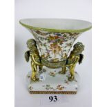 A decorative ceramic planter modelled with brass putti supports est: £40-£60 (B7)