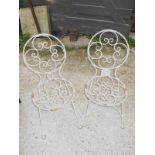 A pair of white painted iron garden chairs est: £20-£30