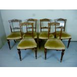 A Victorian set of six dining chairs wit