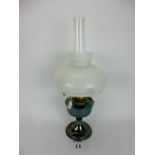 An oil lamp with opaque shade est: £15-£