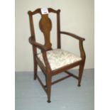 A 1920's mahogany elbow chair with pale