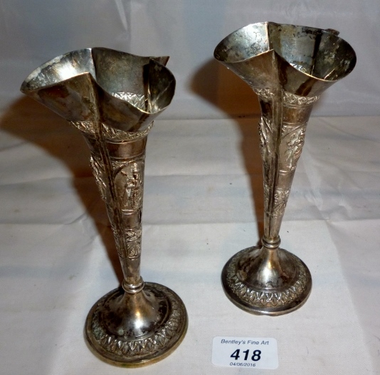 A pair of embossed Indian vases est: £80