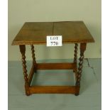 An early 20c oak low side table with bar