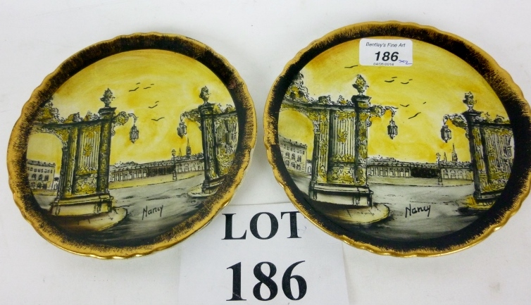 A pair of hand painted plates titled 'Na