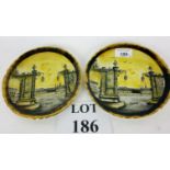 A pair of hand painted plates titled 'Na