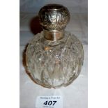 A large cut glass scent bottle with silv