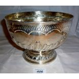 A large silver rose bowl with embossed f