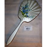 A silver and white enamelled hand mirror