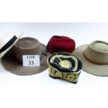 A collection of five assorted hats to include a panama, two smoker's hats,