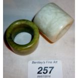 A Chinese white jade Archer's thumb ring and a green jade one est: £30-£40
