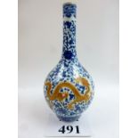 A Chinese blue and white bottle vase decorated with iron-red and gilt dragons,