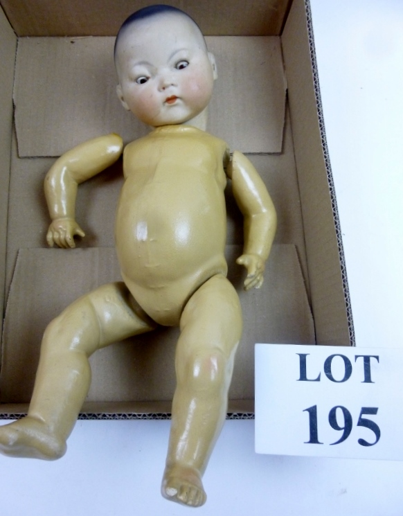 An Armand Marseilles Oriental doll impressed marks 'AM 353/32' with open/close brown eyes,