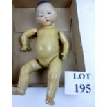 An Armand Marseilles Oriental doll impressed marks 'AM 353/32' with open/close brown eyes,