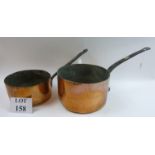 A large heavy copper saucepan with stamp 'Trust House Ascot' and cast iron handle;