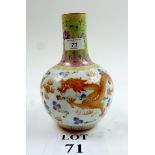 A Chinese Famille rose bottle vase decorated with iron-red and gilt dragons chasing flaming pearls,
