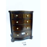 A small serpentine fronted and inlaid apprentice chest est: £200-£300 (A1)