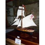 A model wooden sloop with rigging and sails in glass case est: £200-£300 (E)