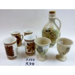 A set of four Rye pottery mugs and Sussex pottery owl painted bulbous decanter and two goblets est: