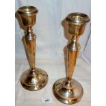 A pair of plain silver candlesticks (app