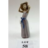 A small Lladro figurine of a young woman