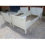 A pair of white painted Victorian single beds complete with slats est: £100-£200