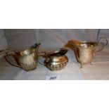 A collection of three silver cream jugs