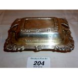 An unusual silver butter dish in the sha