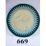 A paper plate with signature 'Pele' est: