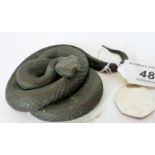 A realistic bronze animaliar figure a coiled snake,